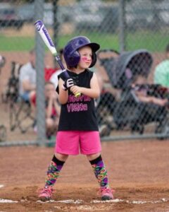 Girl Batting in softball game