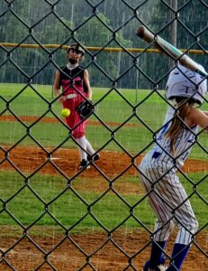 Fastpitch softball pitcher in rain